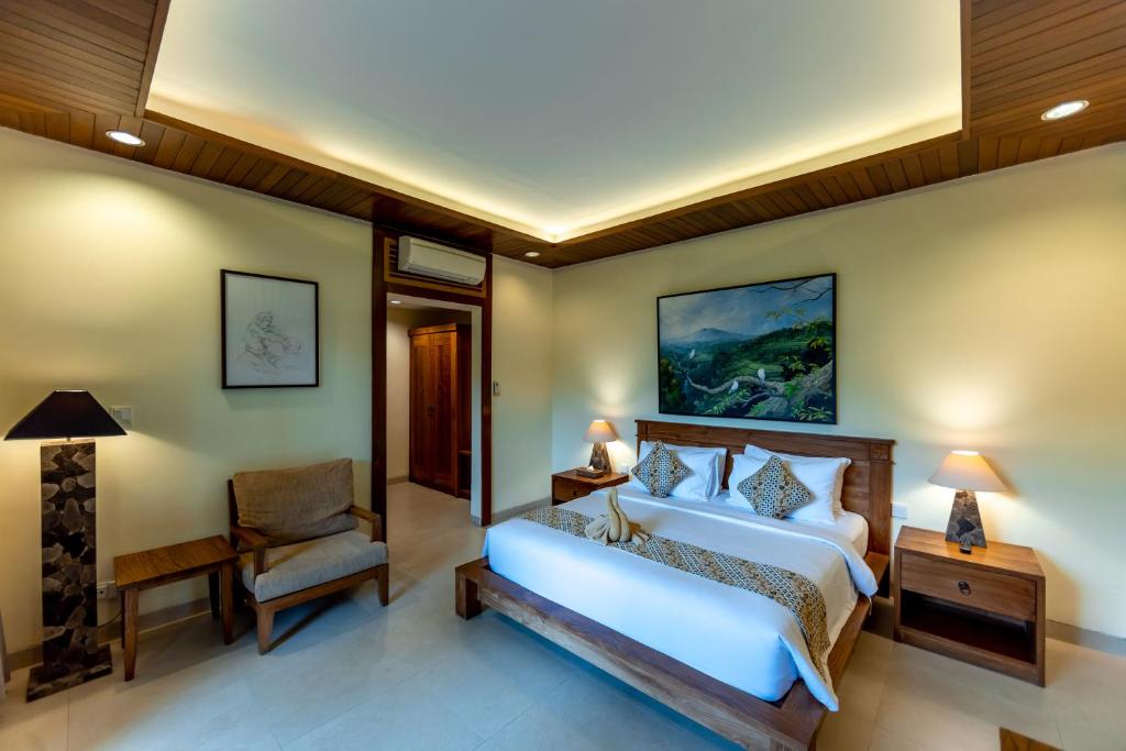 Postel nebo postele na pokoji v ubytování Anumana Village Ubud