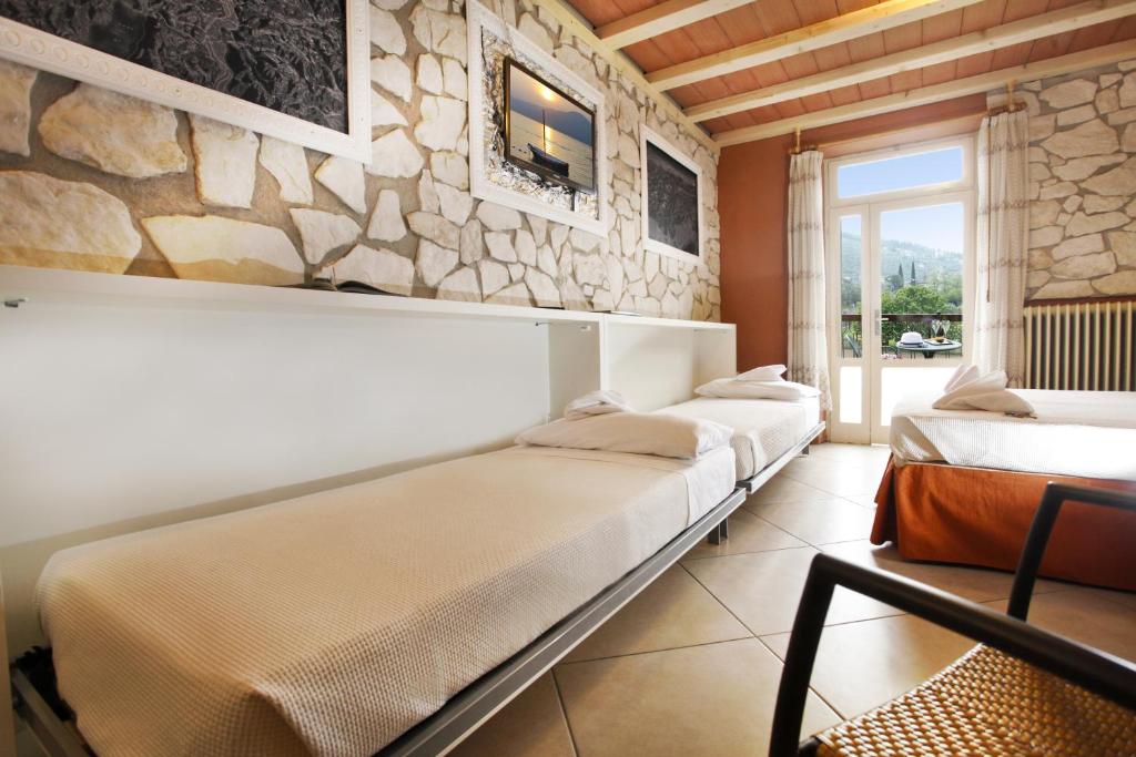 Postel nebo postele na pokoji v ubytování Albergo Garni Orchidea