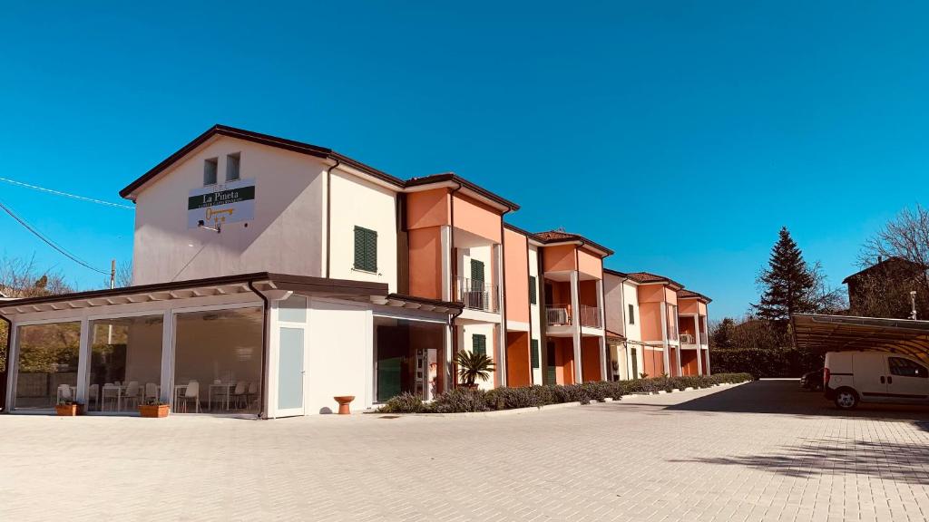 a building on a street with a parking lot at RTA La Pineta in Sarzana