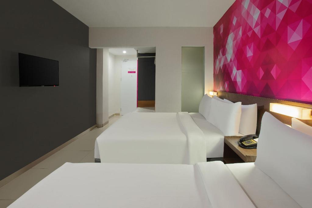 Postel nebo postele na pokoji v ubytování favehotel Simpang Lima - Semarang