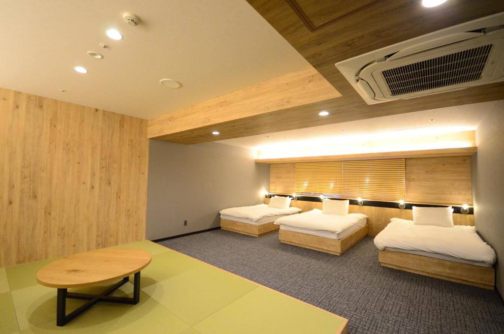 Postel nebo postele na pokoji v ubytování First Cabin Midosuji Namba