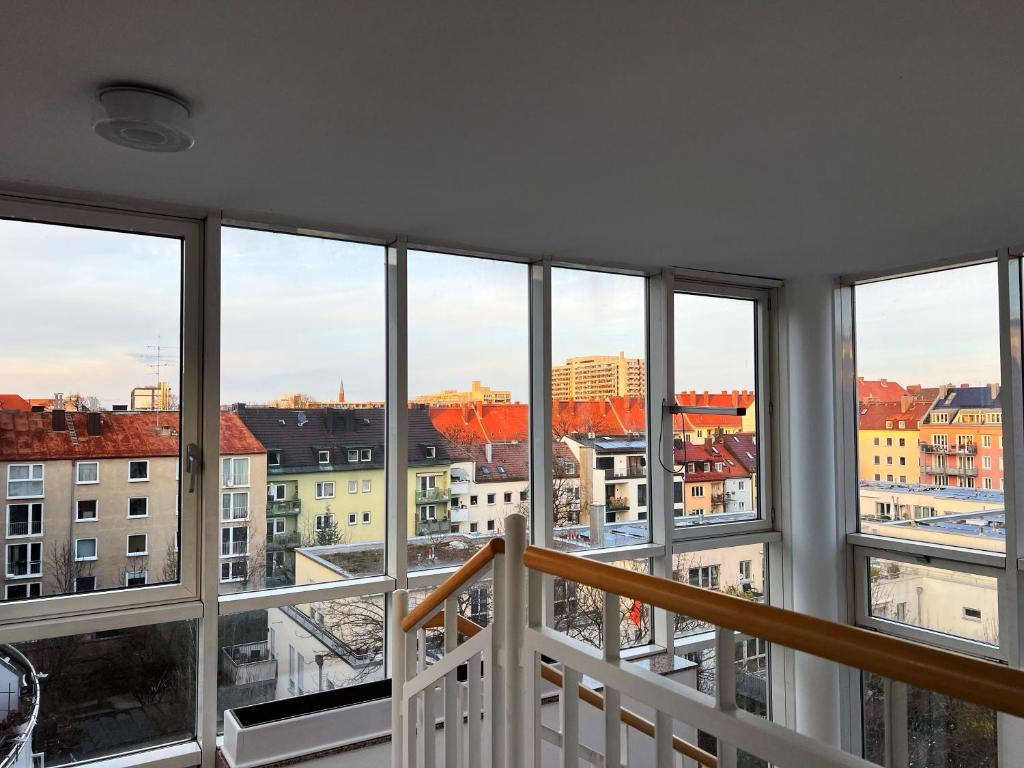 a view of a city from a room with windows at Hotel Prinz in Munich