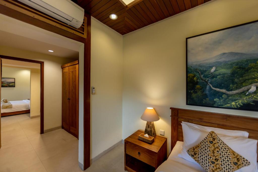 Postel nebo postele na pokoji v ubytování Anumana Village Ubud