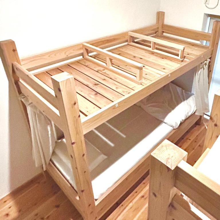 Postel nebo postele na pokoji v ubytování kotobukian 寿庵