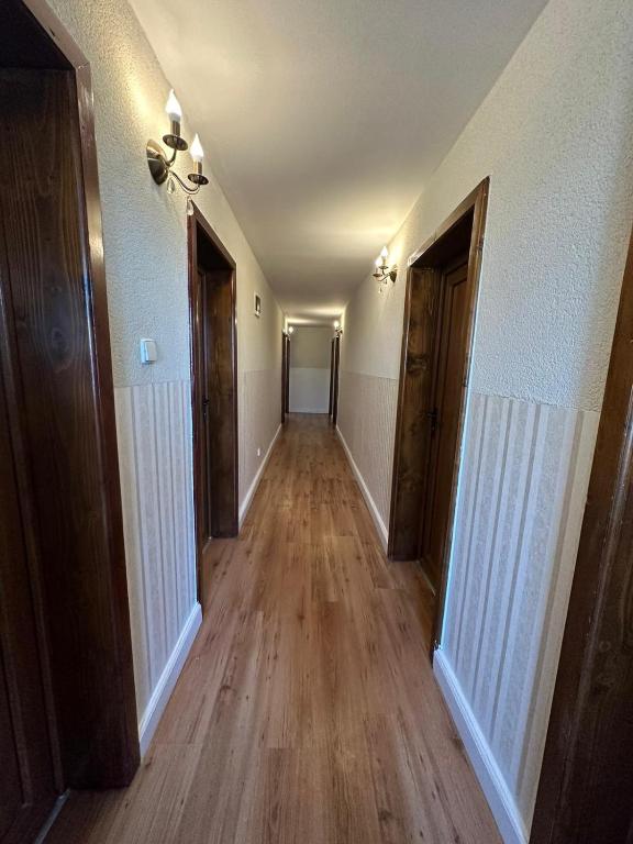an empty hallway in a house with wooden floors at ROUTE79 in Nojorid