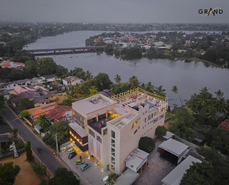 an aerial view of a large white building next to a river at GRAND BOLGODA RESORT in Moratuwa