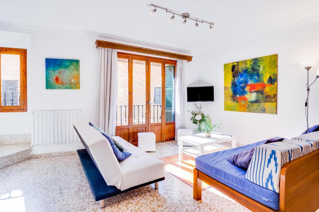 a bedroom with a bed and a couch and a chair at Cas Sastre 8 in Alcudia
