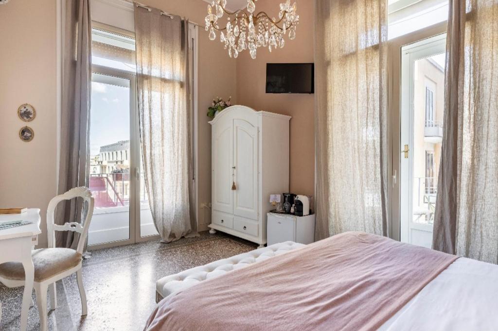 Postel nebo postele na pokoji v ubytování Joy's Bnb Ortigia