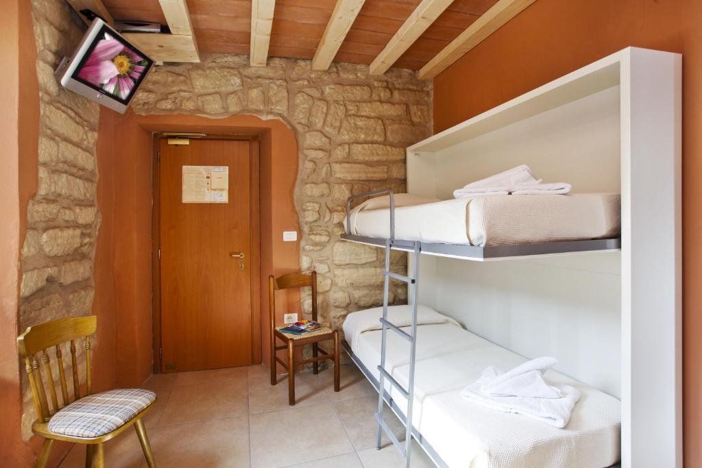 Postel nebo postele na pokoji v ubytování Albergo Garni Orchidea