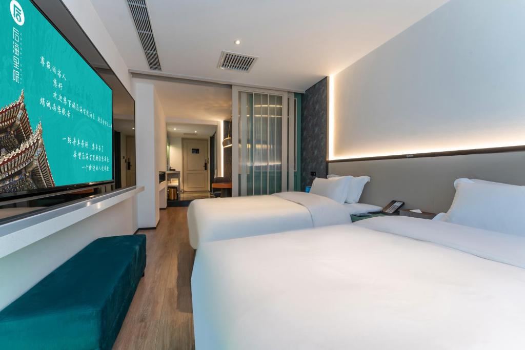 Postel nebo postele na pokoji v ubytování Houhai Hotel