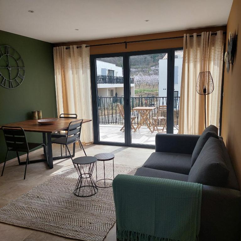 un salon avec un canapé et une table dans l'établissement Les Maisons de Gaugin Studio Le Lézard aan de voet van de Mont Ventoux, à Malaucène