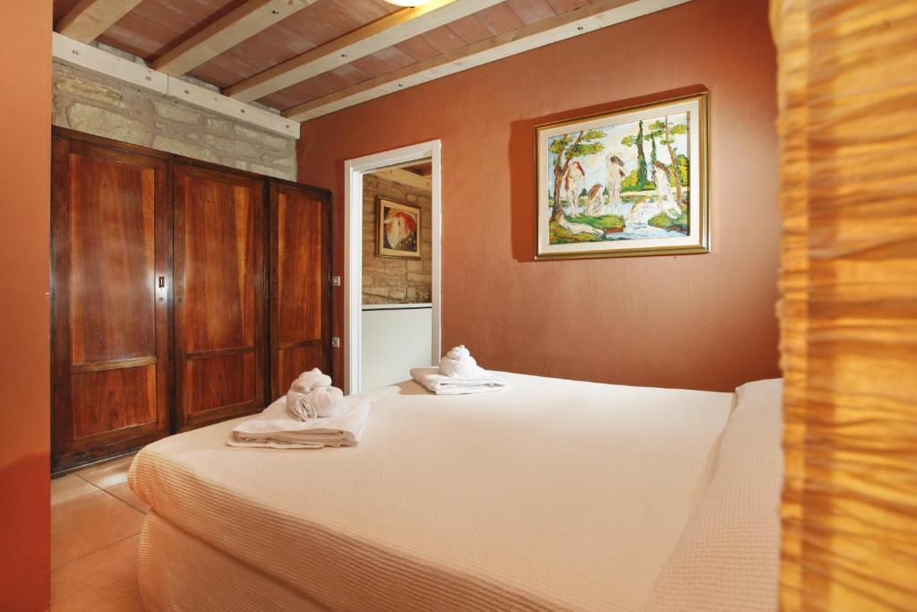 Postel nebo postele na pokoji v ubytování Albergo Garni Orchidea