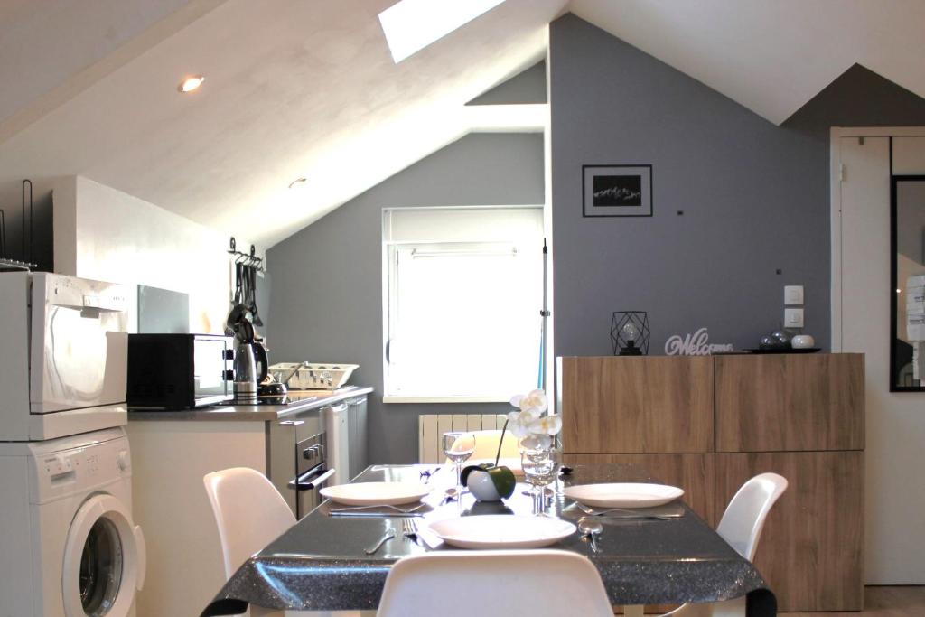 a dining room with a table and chairs in a kitchen at Cosynest in Amnéville