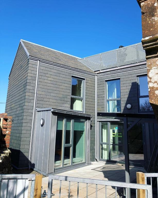 a house with large sliding glass doors on it at New Town Hall Bunkhouse in Whithorn
