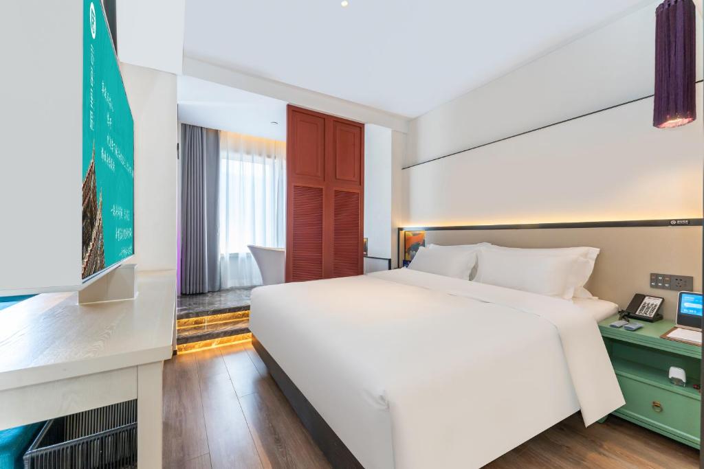Postel nebo postele na pokoji v ubytování Houhai Hotel