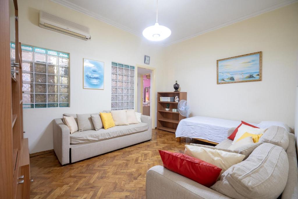 a living room with a couch and a bed at Kipseli 1 bedroom 5 persons apartment by MPS in Athens