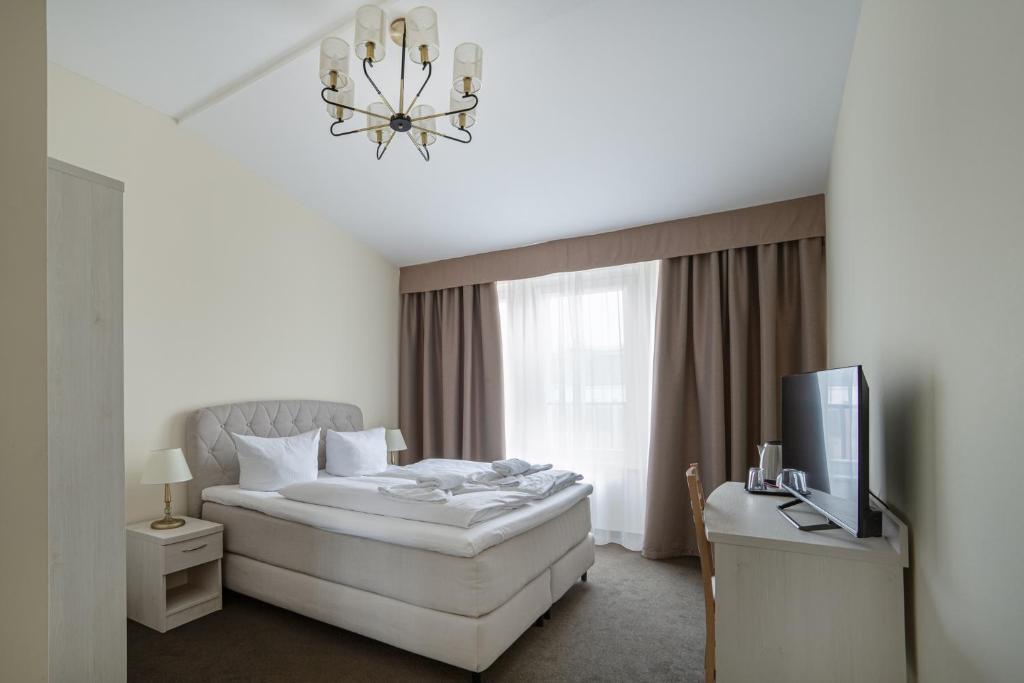 Postel nebo postele na pokoji v ubytování Upper Room Hotel Kurfürstendamm