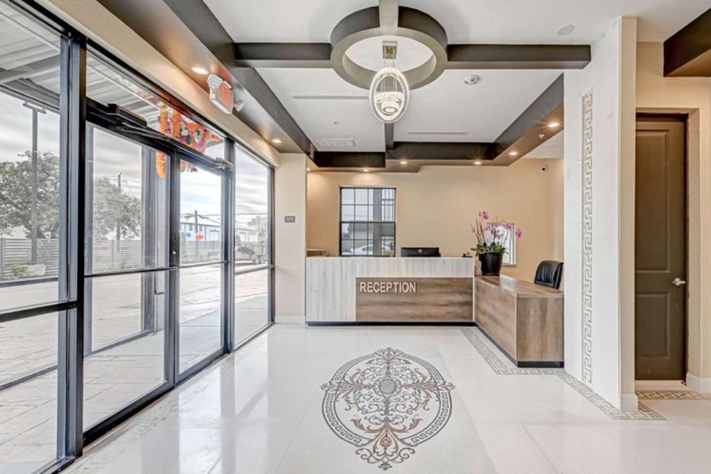 an office lobby with a reception desk and large windows at Comfeeni Inn and Suites in Houston