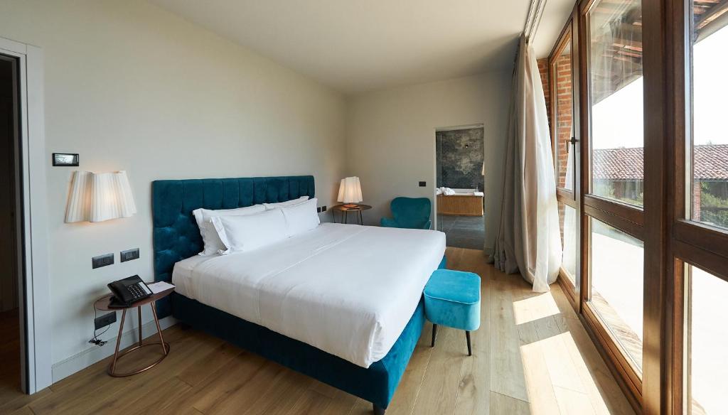 Postel nebo postele na pokoji v ubytování RELAIS CASCINA ERA