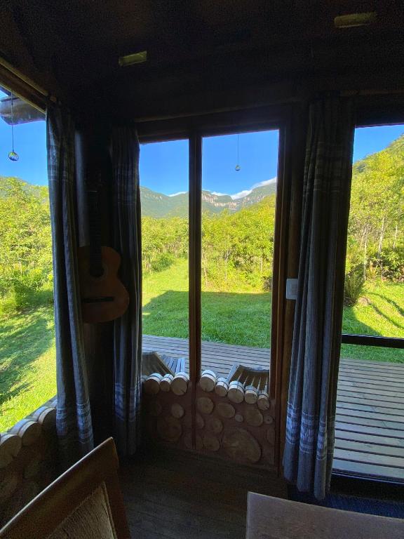 a room with a window with a view of a mountain at Cabana com vista para o canyon in Praia Grande