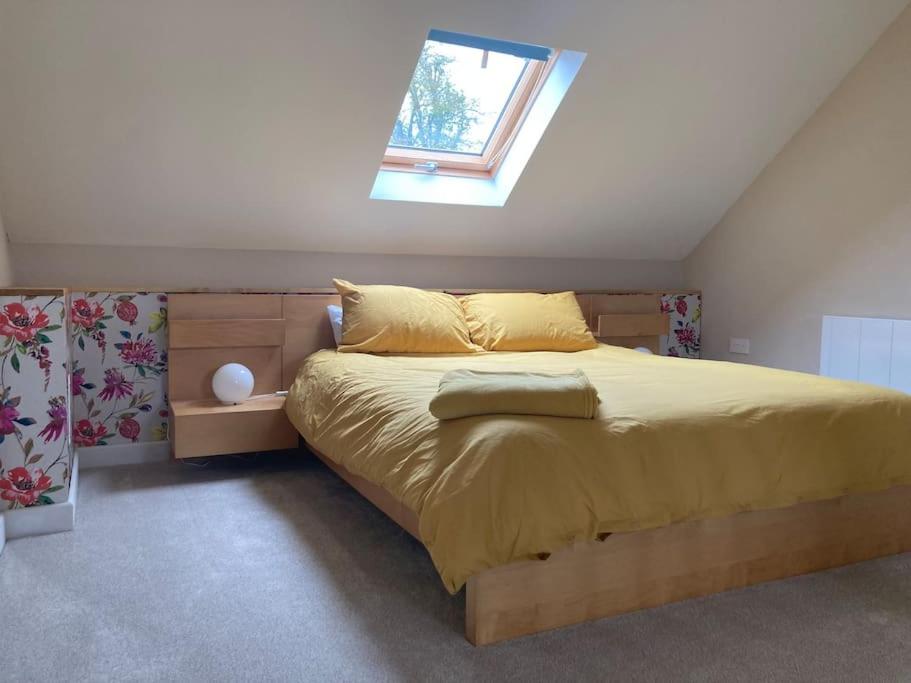 a bedroom with a large bed with a window at Rural Devon retreat in stunning Exe Valley. in Exeter
