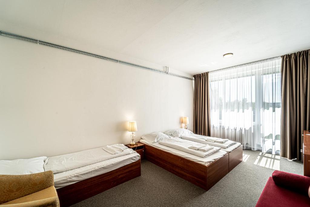 Postel nebo postele na pokoji v ubytování Hotel Fontána