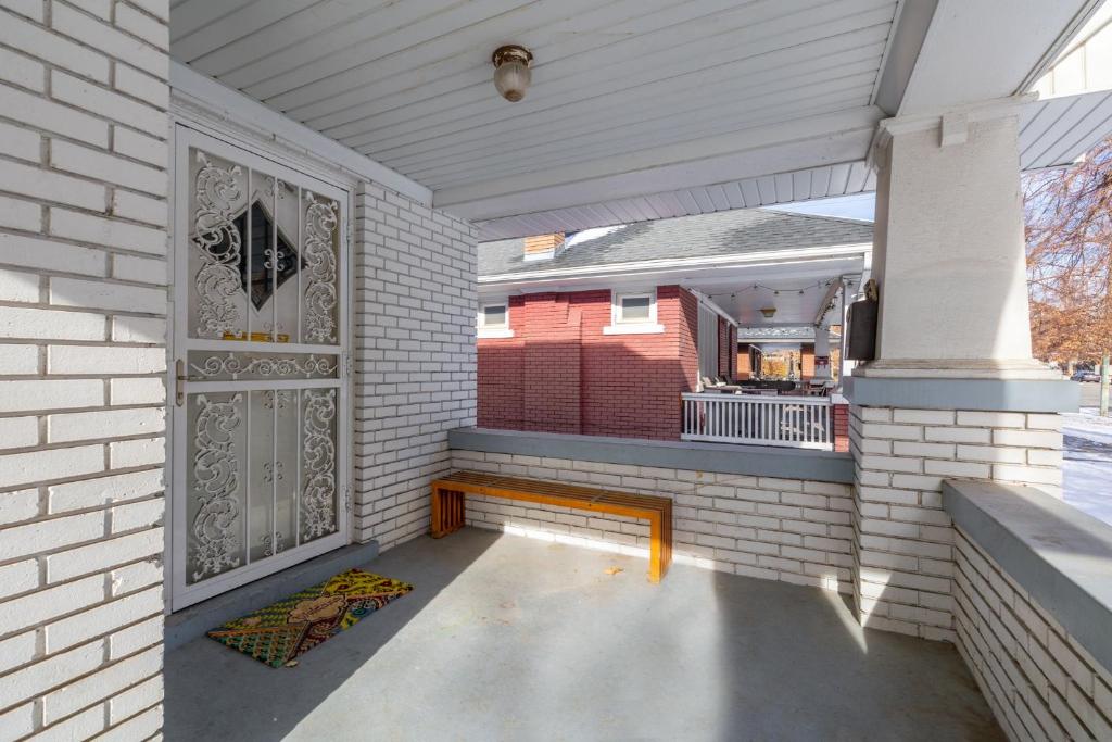 a porch with a wooden bench on a house at 2 Bedroom Near Trolley Square and Liberty Park! in Salt Lake City