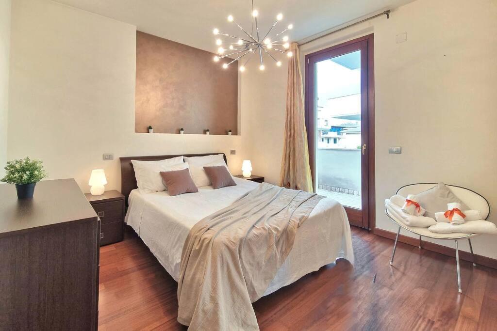 a bedroom with a large bed and a large window at [Raffinata Dimora] Wi-fi Parcheggio Privato Balcone Abitabile in Porto SantʼElpidio