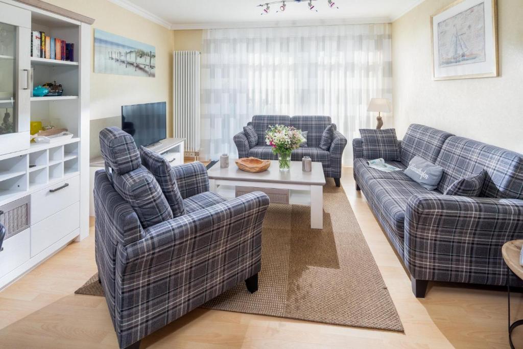 ein Wohnzimmer mit zwei Sofas und einem Fernseher in der Unterkunft Haus Friederike in Norderney