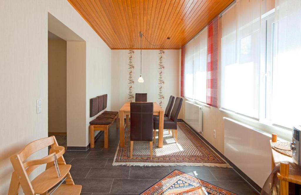 a dining room with a table and some chairs at Haus Mimi in Norderney