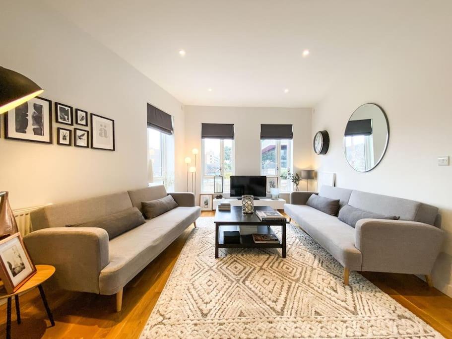 a living room with two couches and a table at Amazing and 3 bedroom house in Deptford in London