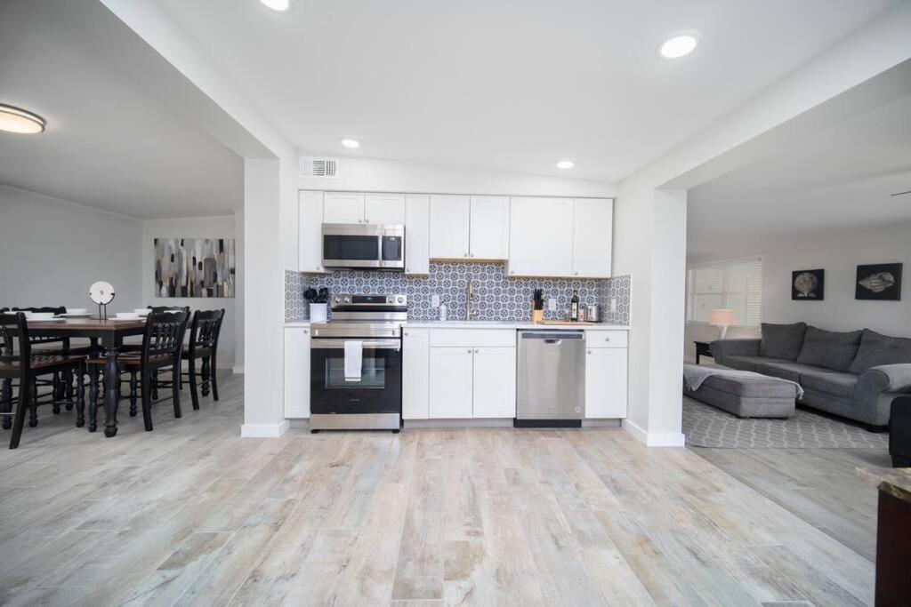 a kitchen and living room with a couch and a table at Fully Renovated house 10 min to Mayo Clinic in Jacksonville