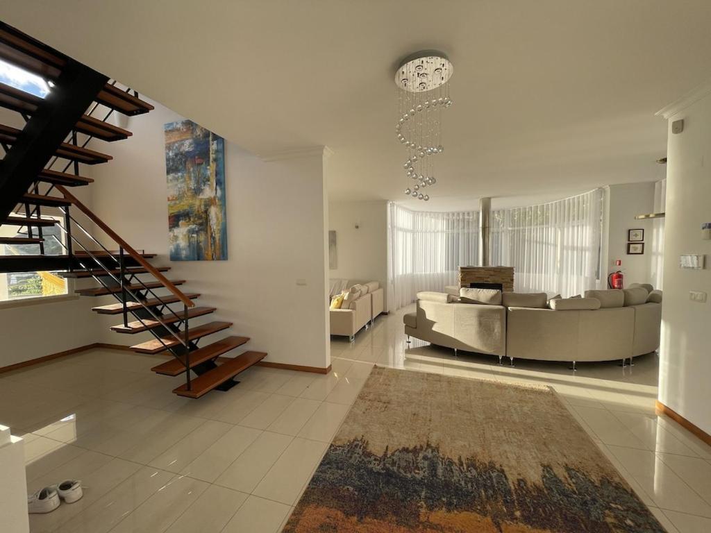 Posezení v ubytování Luxury villa with private heated pool, garden and views of the sea and mountains.