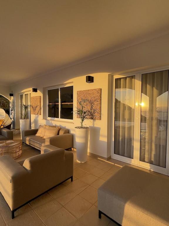 Posezení v ubytování Luxury villa with private heated pool, garden and views of the sea and mountains.