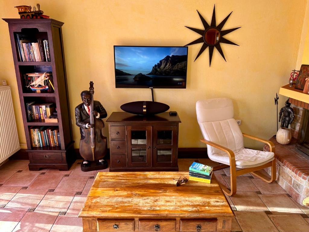 a man standing in a living room with a guitar at Aegean Blue House - Spectacular Seaview in Kalámion