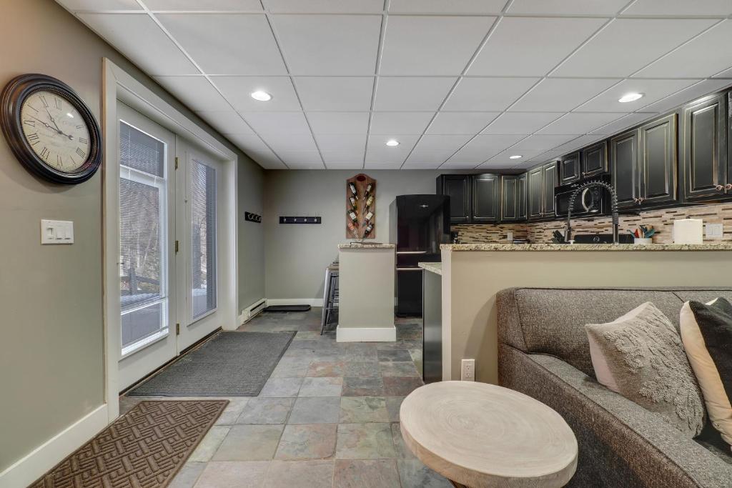 a living room with a couch and a clock on the ceiling at 691 Disciples Village Condo in Boyne Falls