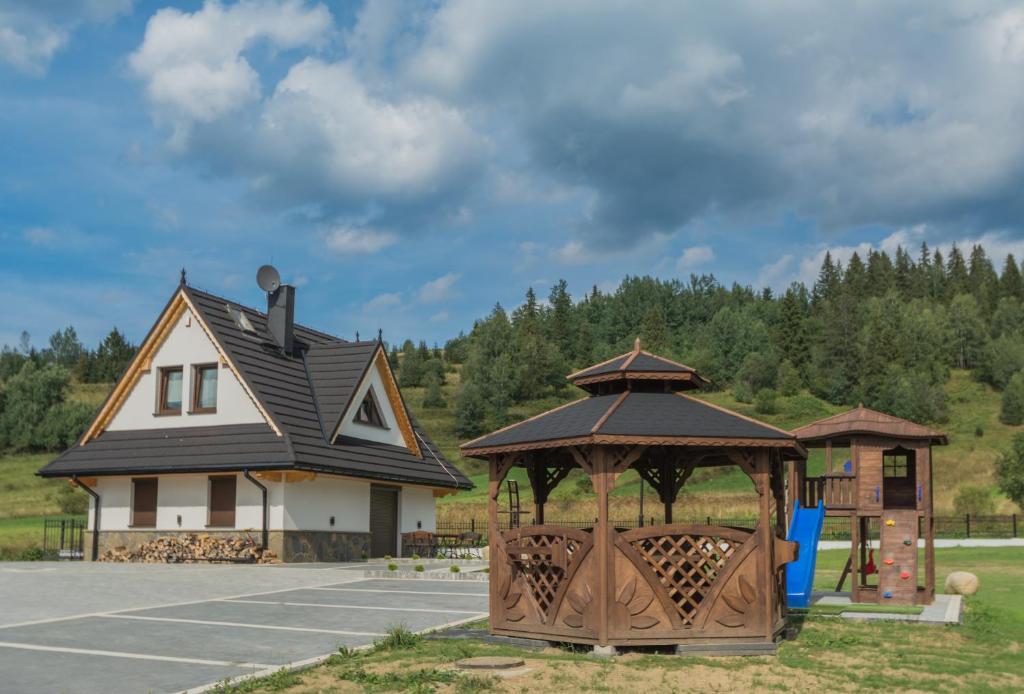 a playground with a gazebo in front of a house at TatryTop Narciarski Jurgów in Jurgów