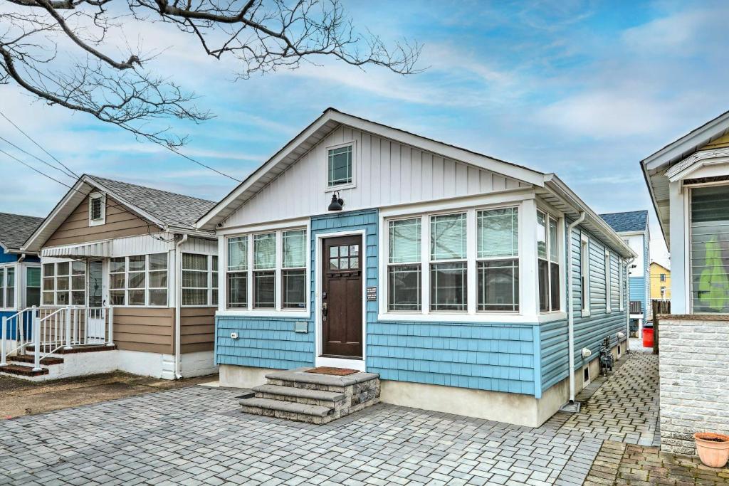 a home with a blue and white house at Beach Retreat with BBQ, Patio and Outdoor Shower! in Seaside Heights