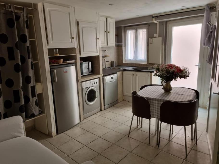 a kitchen with a table and a sink and a dishwasher at Croisette Immo vieux port 6pièces 12 personnes in Cannes