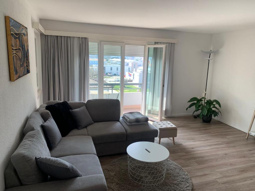 a living room with a couch and a table at Caslano City Apartments in Caslano
