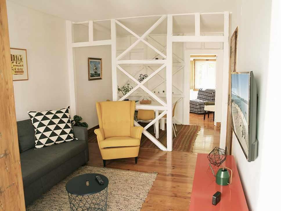 a living room with a couch and a bed at Typical Portuguese Apartment in São Bento in Lisbon