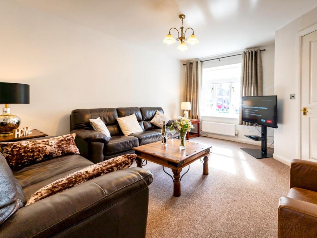 uma sala de estar com um sofá, uma mesa e uma televisão em Pass the Keys Town Location for Shrewsbury with 3 Bedrooms em Shrewsbury