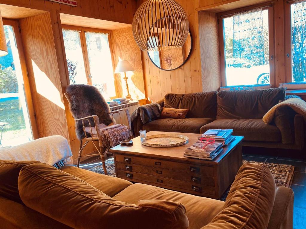 a living room with couches and a coffee table at Chalet Savoyard avec Cheminée et Parking à Samoëns - FR-1-624-80 in Samoëns