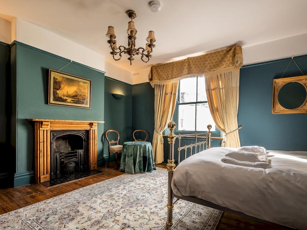 a bedroom with a bed and a fireplace at Pass the Keys Characterful period home in heart of Chagford in Chagford