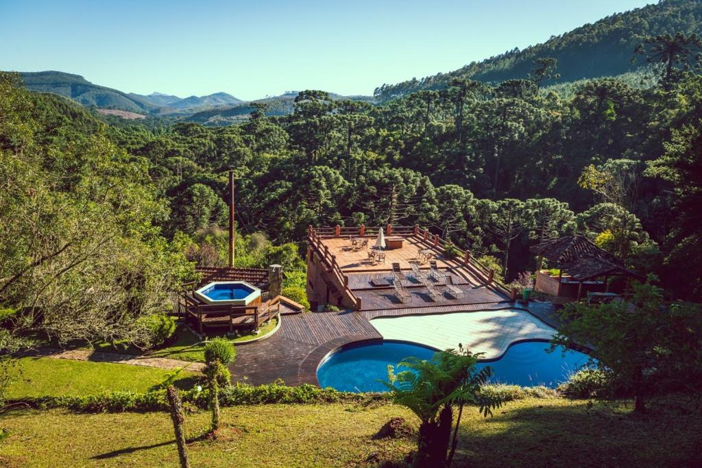 an aerial view of a house with two swimming pools at Fazenda Hotel Itapuá in Monte Verde
