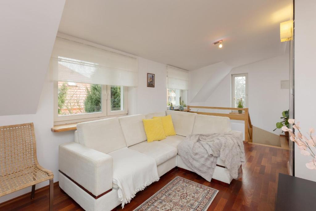 a living room with a white couch and a window at Quiet Bemowo House with Garden by Renters in Warsaw