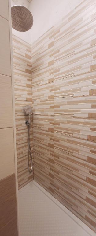 a bathroom with a shower with a wooden wall at Albergo Annabella in Santa Margherita Ligure