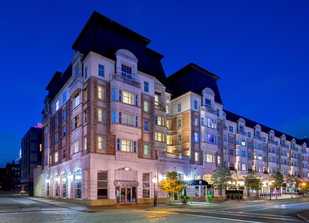 a large building on a city street at night at Hotel Commonwealth in Boston