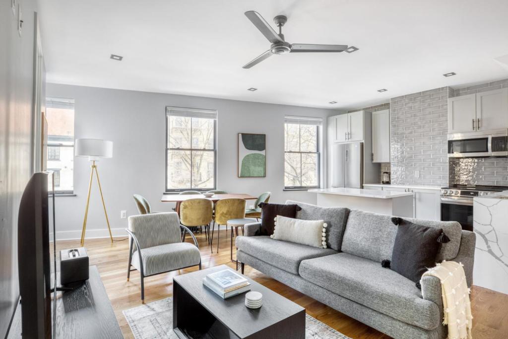 a living room with a couch and a kitchen at West Village 3br w wd nr Pier 46 NYC-1098 in New York