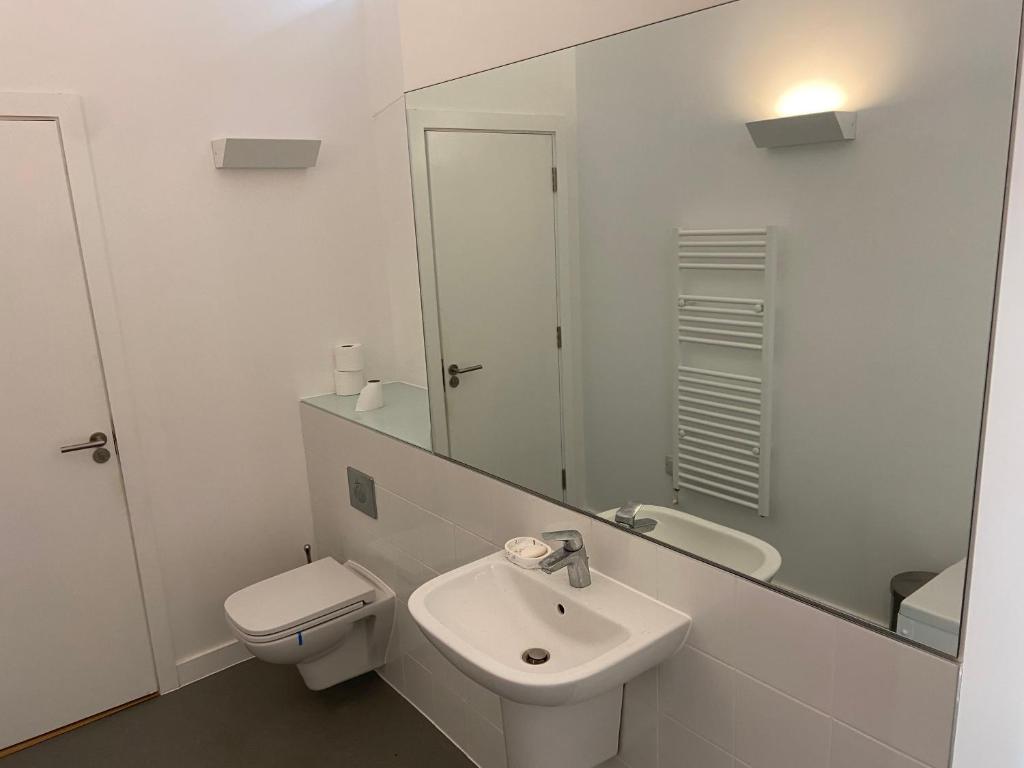 a bathroom with a sink and a toilet and a mirror at Shared with Host Lister Pods Executive Penthouse in Bradford